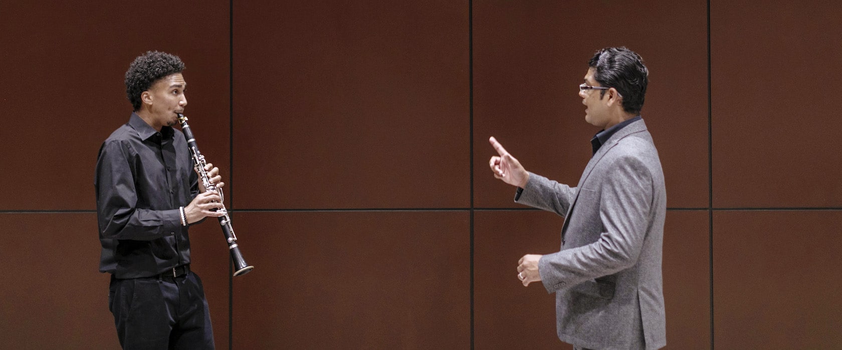Student playing clarinet with professor
