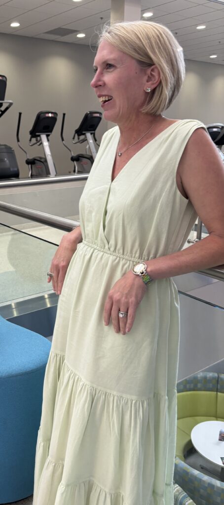 woman wearing long green dress in wellness facility